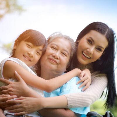 3 generation photo of 3 women hugging and smiling outside