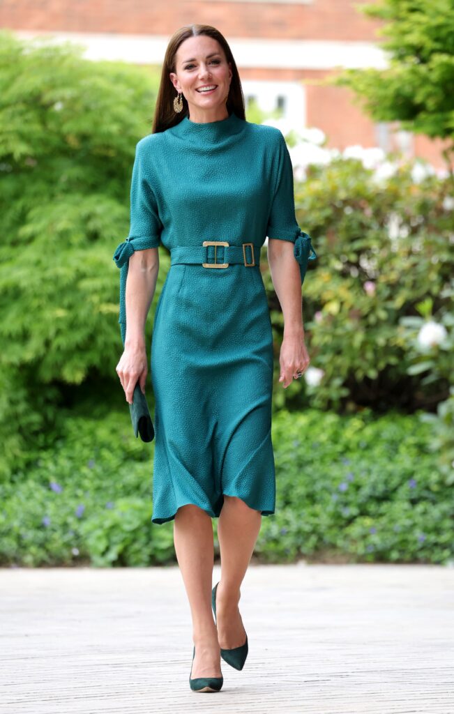 Kate Middleton wearing a teal dress with emerald bag and pumps at the Design Museum on May 04, 2022 in London, England