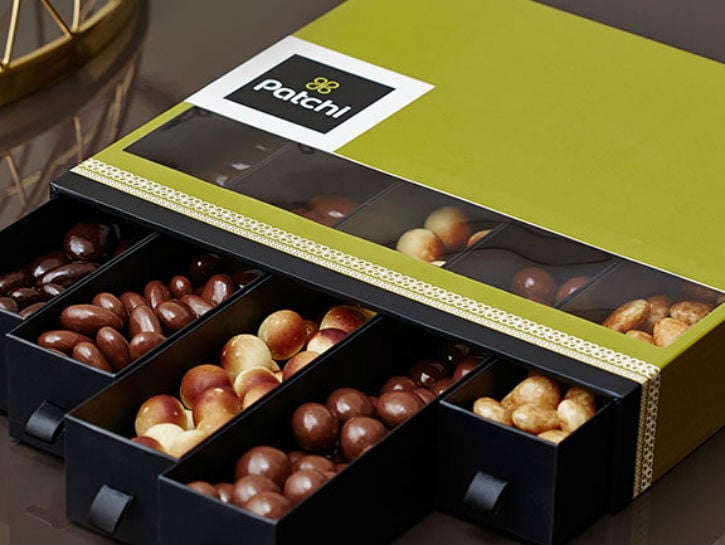 Open box with various Patchi chocolates and treats. 
