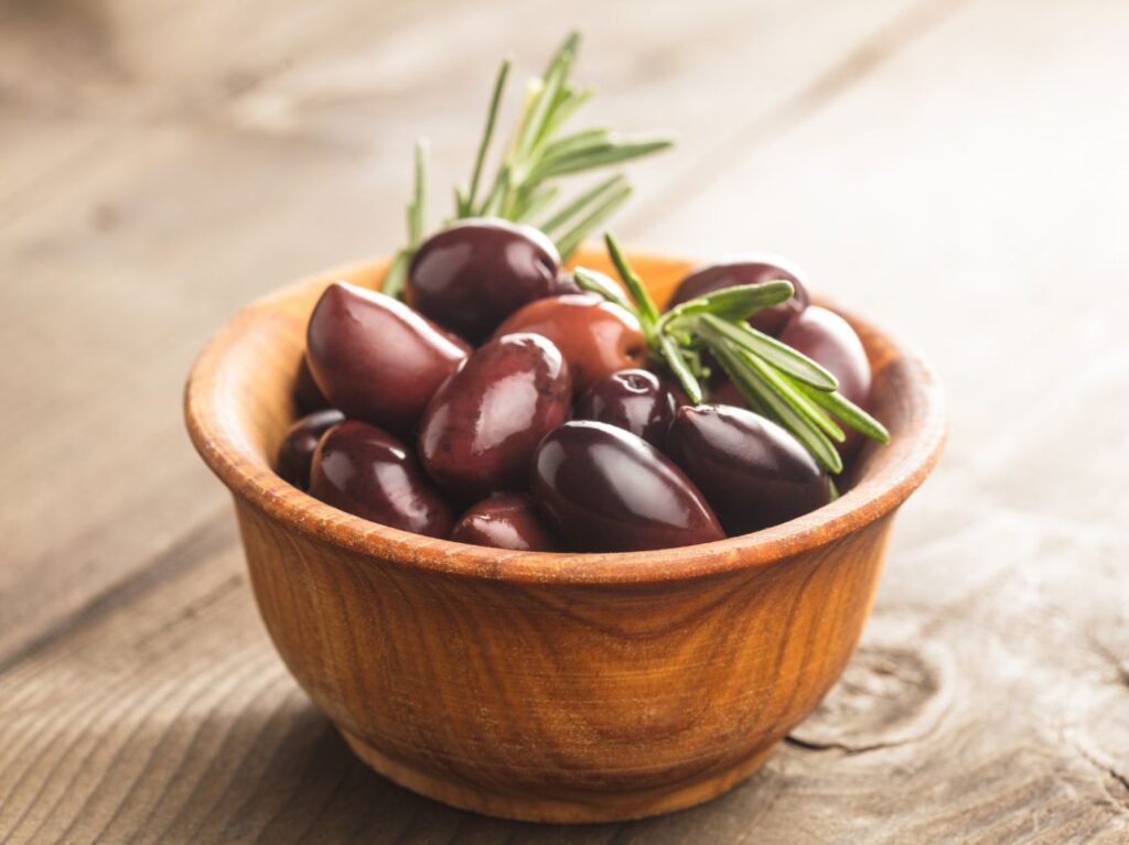 Small bowl of kalamata olive with fresh herbs