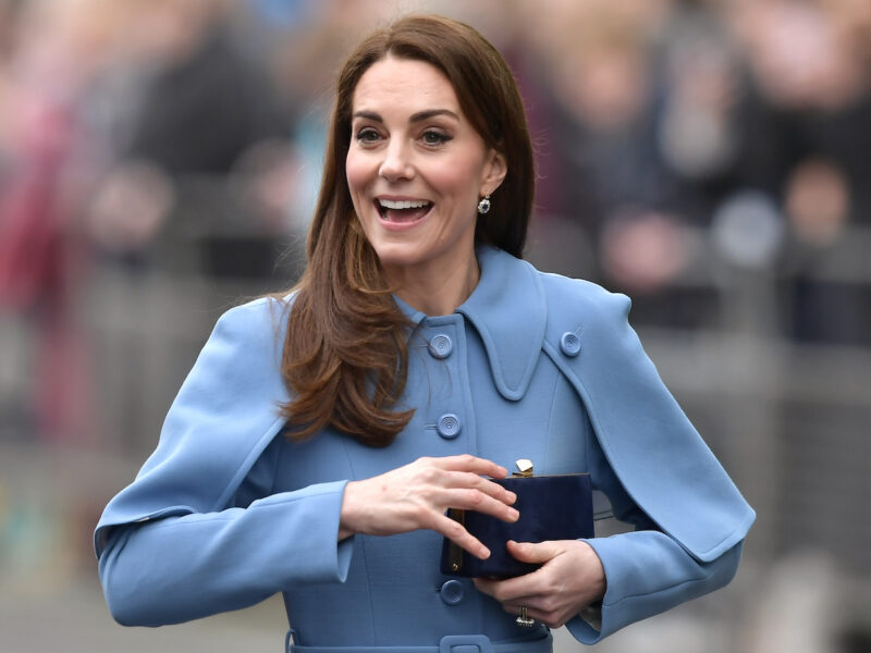 Kate Middleton smiling in a blue coat on a visit to Northern Ireland