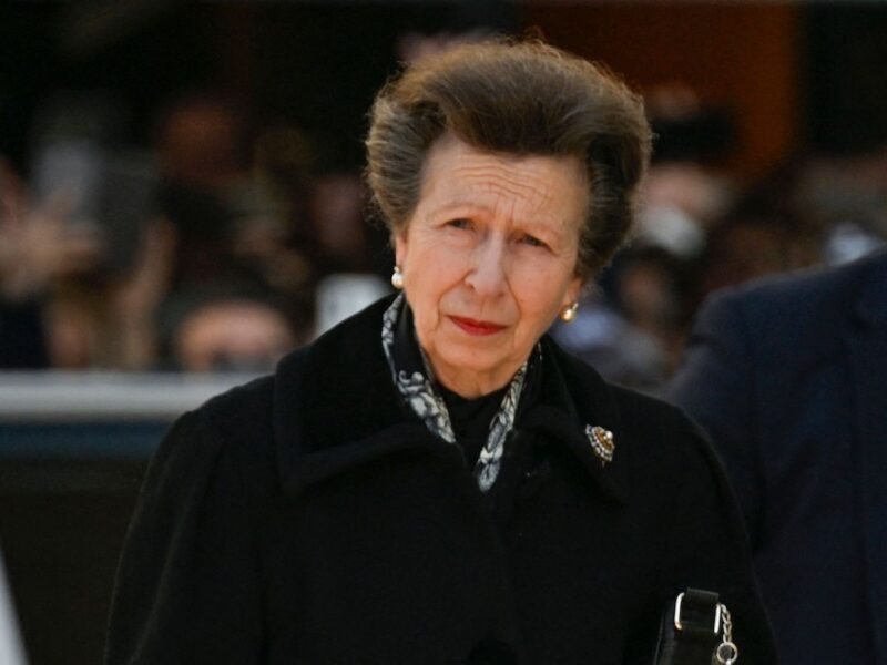 Princess Anne in a black coat with a light ascot and brooch