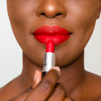 Woman applying red lipstick
