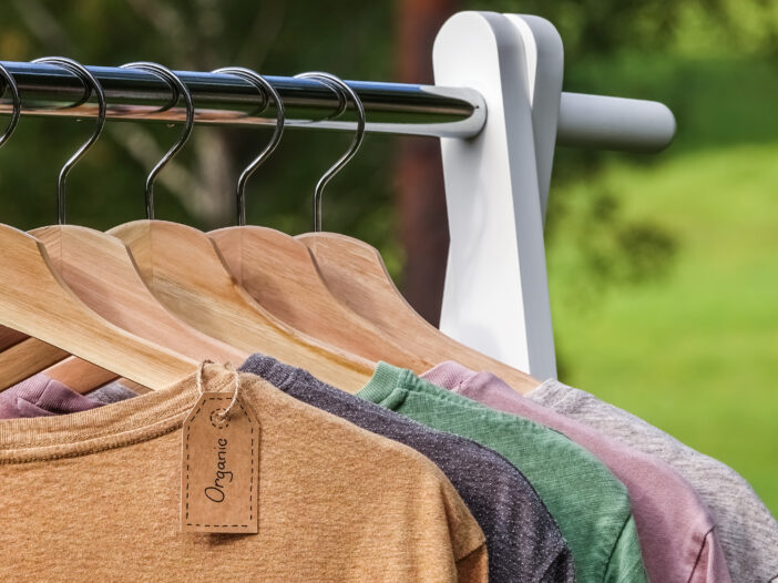 Image of clothes hung up on a rack outside.