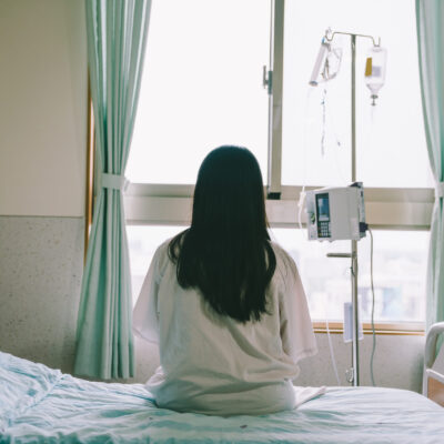 A woman sitting on a hospital bed