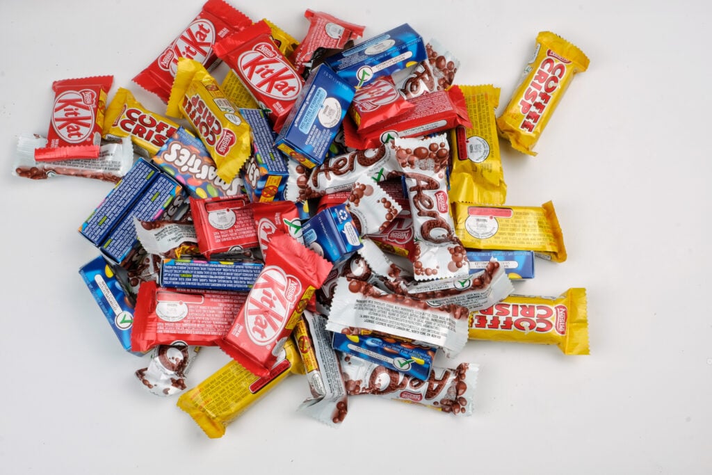 Variety of fun sized Nestle chocolate bars in a pile.