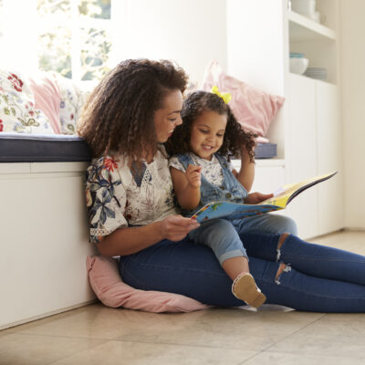 Image of mom reading to her child.