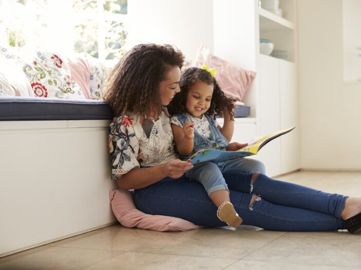 Image of mom reading to her child.