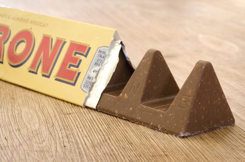 Close up of a Toblerone chocolate bar partially out of its wrapper.