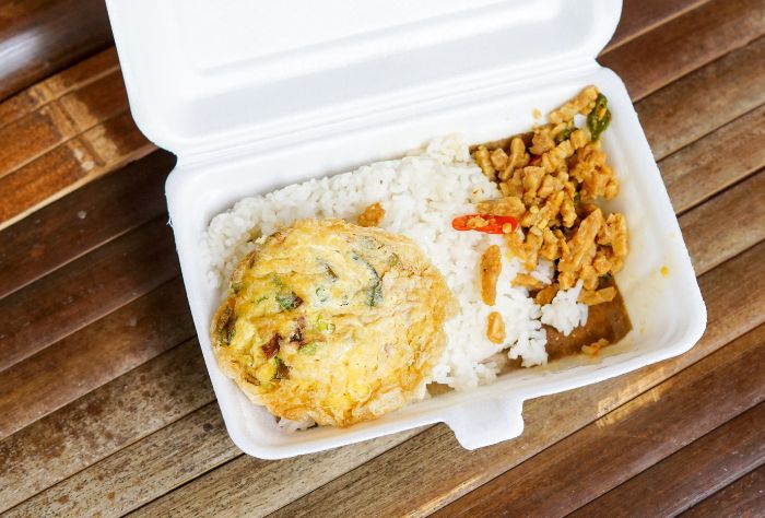 Styrofoam food container with leftover rice and meat