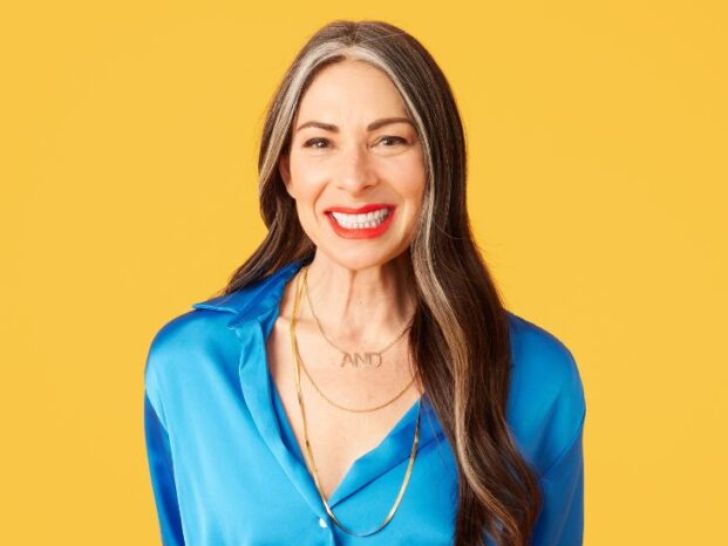 Stacy London, CEO of State of Menopause, poses in a blue outfit