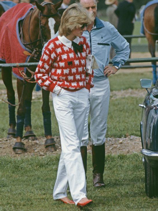 Princess Diana wearing a "black sheep" sweater and white trousers in 1983.