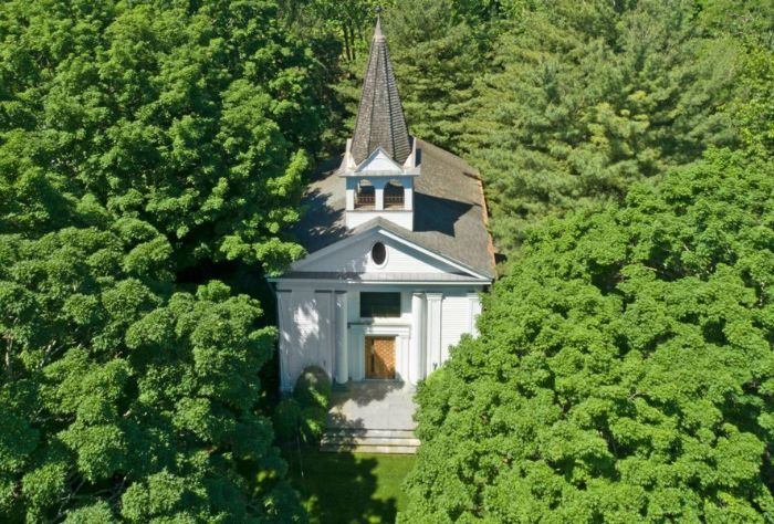 Aerial view of home surrounded by trees
