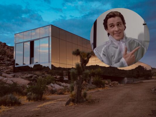 photo of the Invisible House, a rectangular home covered in rectangular reflective window panels in the desert with a cutout of Christian Bale in American Psycho
