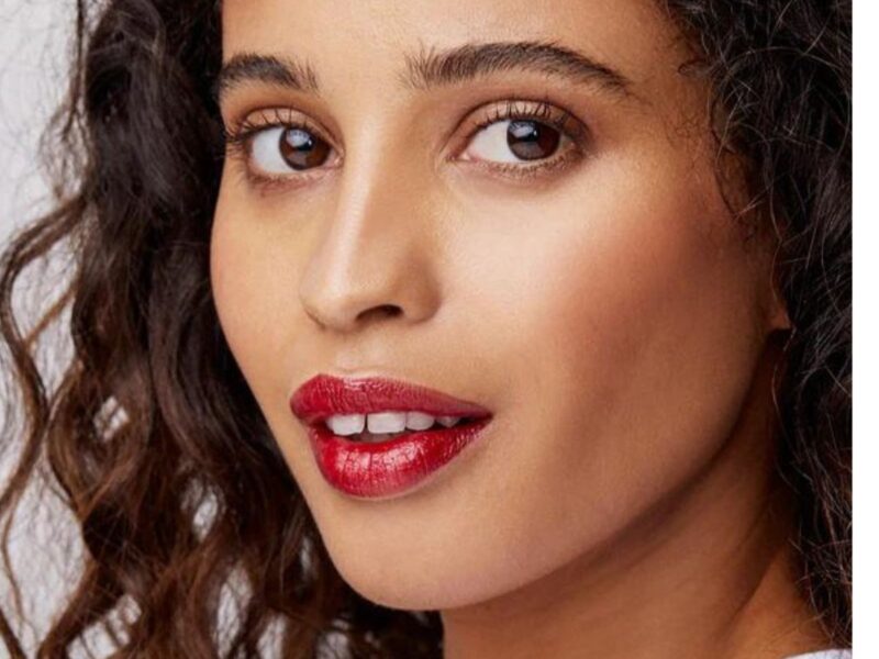 a model with a tooth gap wears red lipstick